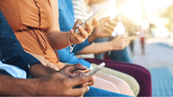 A diverse group of people using their mobile phones