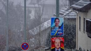 Election posters of Alice Weidel of the AfD and German Chancellor Olaf Scholz are fixed at lamp poles in Niederreifenberg near Frankfurt, Germany, Thursday, Feb. 13, 2025. (AP Photo/Michael Probst)