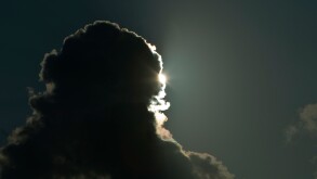 The sun behind rain clouds, Huntington Beach State Park, South Carolina, USA.