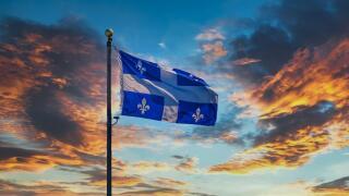 Quebec Flag on Sunset Sky