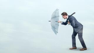 Businessman defying strong headwind
