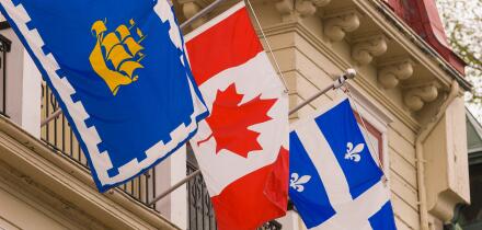 QUEBEC CITY, QUEBEC, CANADA - National and regional flags on display in Quebec City. L-R: City of Quebec; Canada; Quebec