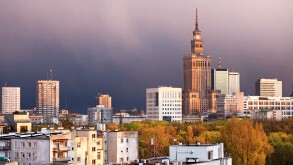 Warsaw, capital city of Poland, featuring Palace of Culture and Science, Srodmiescie district. Sunset time, stormy sky.