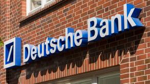 Stade, Germany - May 28, 2020: Signage on brick wall at Deutsche Bank branch . Deutsche Bank is a global Multinational Investment bank and financial s