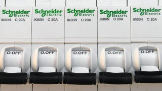 Schneider electric circuit breakers on white background.