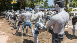 Fighting men statues kick boxing, Muay Thai, at Wat Bang Kung, Bangkok, Thailand