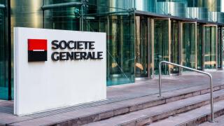 Sign of the Societe Generale at the entrance of the head office of the french banking group in La Defense business district.