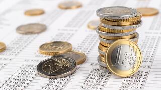 finance business accounting stock background with stack of euro coins on data sheet