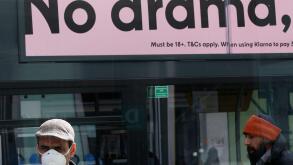 Birmingham, West Midlands, UK. 31st March 2020.  A masked man stands in a Birmingham city centre bus shelter during the Coronavirus pandemic lockdown. Credit Darren Staples/Alamy Live News.