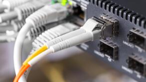 Close-up of high speed fiber network switch and cables in datacenter