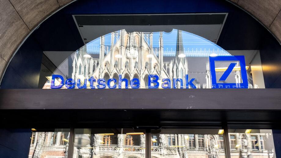 Deutsche Bank logo on the window of a branch in Munich