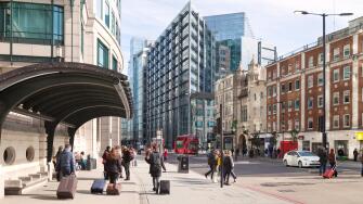People in Bishopsgate, City of London street scene, looking towards the RBS building, Spitalfields East London UK