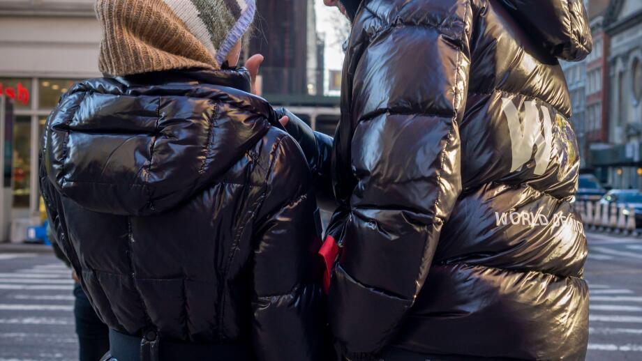 Pedestrians in Chelsea in New York wear Moncler brand parkas on Thursday, December 23, 2021  (© Richard B. Levine)