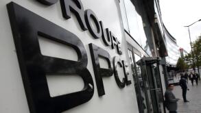 People leave the BPCE bank headquarters in Paris, France, September 24, 2015. A French court on Thursday acquitted BPCE bank Chairman Francois Perol of accusations of having an illegal conflict of interest when he was appointed in 2009 head of France's se