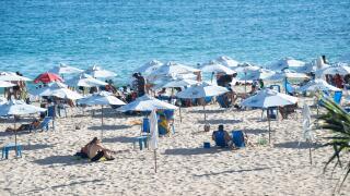 Salvador, Bahia, Brazil - January 24, 2025: Hundreds of people are seen on Paciencia beach sunbathing in the city of Salvador, Bahia.