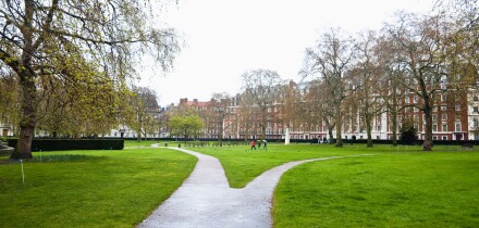 Grosvenor Square, London, W1.  A path diverging - becoming two narrow paths - each going in different directions. UK.