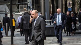 Great Britain / England /London /City of London / A City of London businessman speaking on his mobile phone.