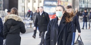 Young woman wearing face mask while walking in the streets of London