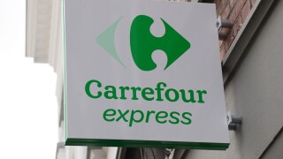 The Carrefour Express logo above a store in Bruges, Belgium.