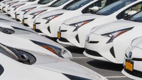 Rows Of White Cars In Car Dealership Parking Lot