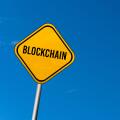 Blockchain - yellow sign with blue sky