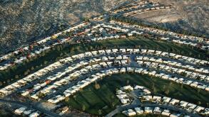 An aerial view shows the sun rising on a Palm Desert housing development in the Coachella Valley in Southern California, USA. This growing retirement haven east of Los Angeles includes the upscale communities of Rancho Mirage and La Quinta, as well as the
