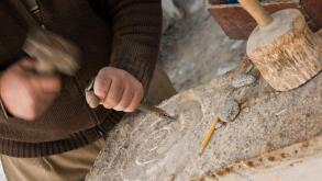 Sculptor chisels the stone, Germany