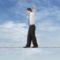Businessman is balancing on a rope
