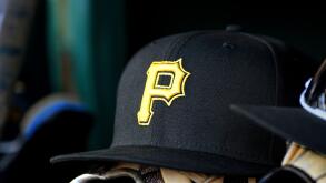 WASHINGTON, DC - APRIL 29: A New Era Pirates baseball hat cap with the yellow P Pirates logo sits on a baseball glove on the dugout bench during the Pittsburgh Pirates versus Washington Nationals MLB game 2 at Nationals Park on April 29, 2023 in Washingto