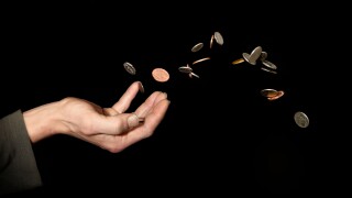 Caucasian male (42 yrs old) hand with money in the air depicting the concept of ?throwing money away?