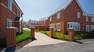 An empty street in a mostly complete new housing development