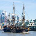 Gotheborg of Sweden, a sailing replica of the Swedish East Indiaman Gotheborg I, visiting London, UK. London city skyline, financial district