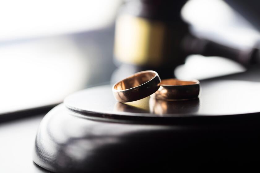 Divorce law concept. Wedding ring and gavel.