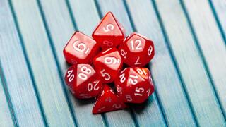 Lots of simple red RPG game dice, polyhedral dice set for role playing games and scenarios, top view. Dices group closeup. Tabletop board games