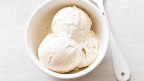 Vanilla ice cream scoops in white bowl
