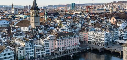 Zurich, Switzerland, Jan. 4, 2026. View of Zurich from Grossmunster tower showing the snowy rooftops, the Limmat river and the St. Peter church