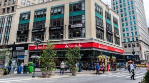 New York City, USA - July 31, 2018: Facade of a bank branch of Santander Bank and a pharmacy with people around in Manhattan, New York City, USA