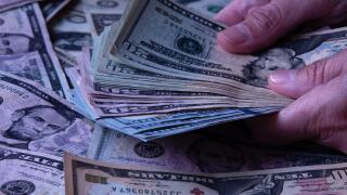 Woman's hands holding American dollars banknotes