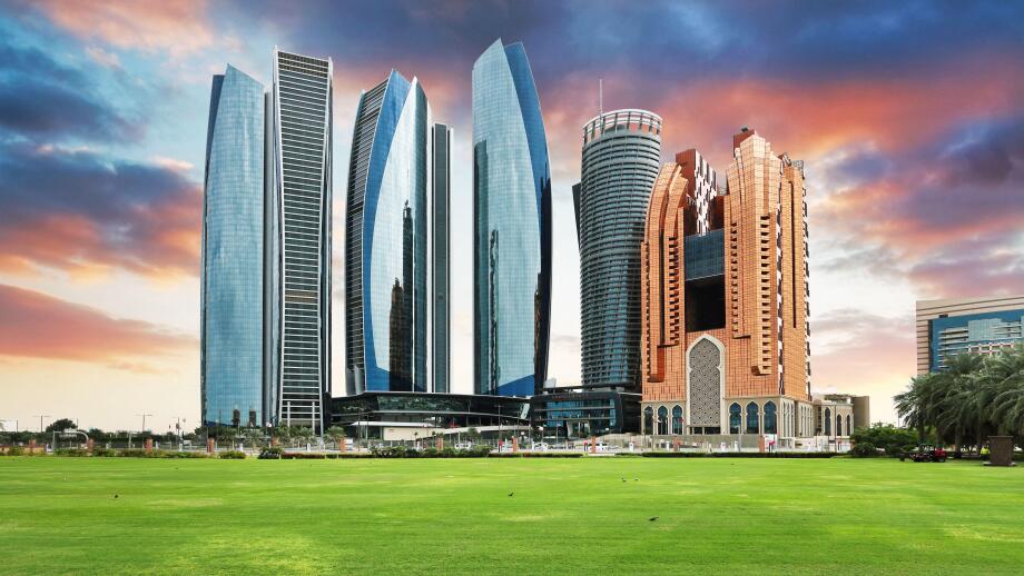 Skyscrapers in Abu Dhabi at dramatic sunset; United Arab Emirates