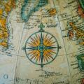Close-up of a vintage globe showing Europe and the North Atlantic with a detailed compass rose.