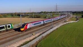 A Virgin Pendolino heads a Glasgow bound service north through Litchfield Trent Vallet while a London Midland stopper heads sout