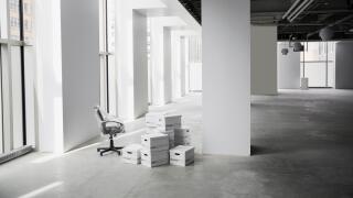 Office chair and boxes in empty office