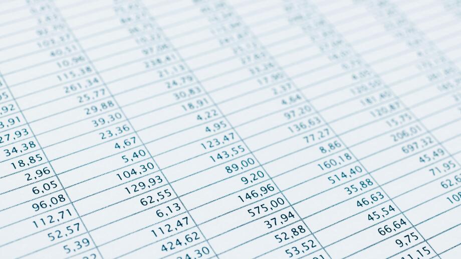Business data report selective focus close up. Monthly stock stats spreadsheet. Blue toned.