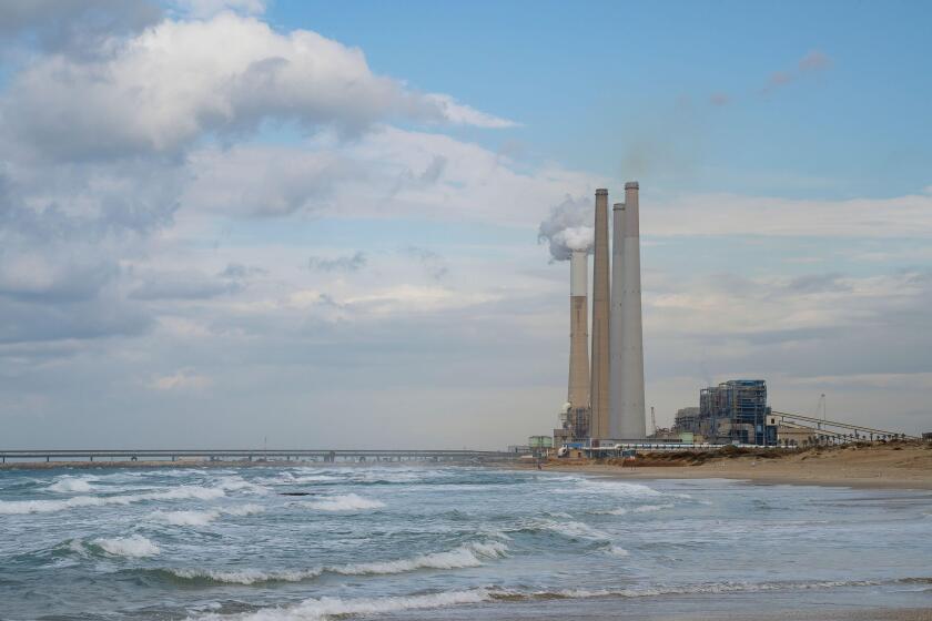 Hadera, Israel - December 16th, 2021: The coal operated "Orot Rabin" power station on the mediterranean beach next to Hadera, on a hazy, cloudy day.