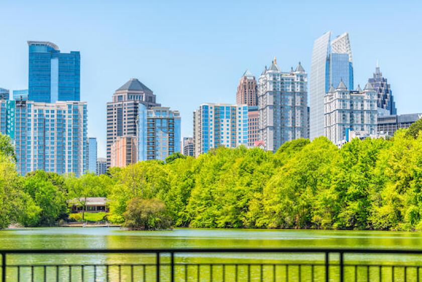 Atlanta, USA - April 20, 2018: Cityscape skyline view in Piedmont Park in Georgia downtown green trees, scenic urban city skyscrapers with railing in