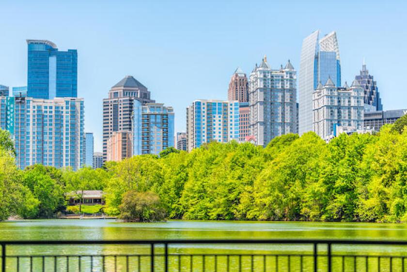 Atlanta, USA - April 20, 2018: Cityscape skyline view in Piedmont Park in Georgia downtown green trees, scenic urban city skyscrapers with railing in 