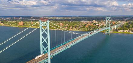 Detroit, Michigan - The Ambassador Bridge, linking the United States (foreground) and Canada over the Detroit River.