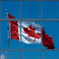 A Canadian flag reflected in the glass of an office building in Halifax, Nova Scotia