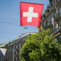 Swiss flag flying in streets of Zurich, Switzerland