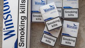 Winston blue cigarettes packaging features prominent health warnings in English, which state "Smoking kills" and "Smoking seriously harms you and othe